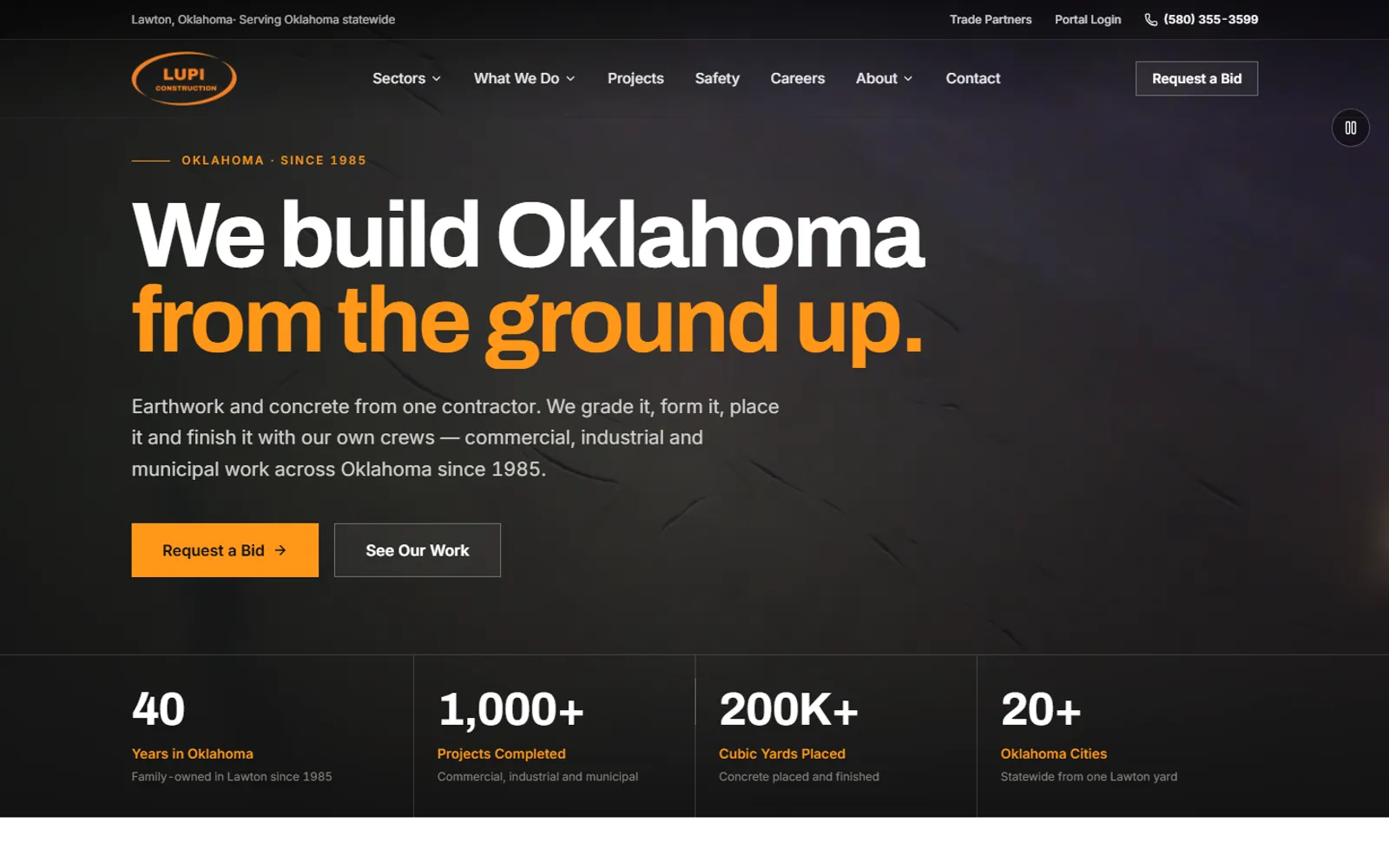 Lupi Construction homepage hero: 'We build Oklahoma from the ground up.' over a dark video background, with Request a Bid and See Our Work buttons and a row of company stats